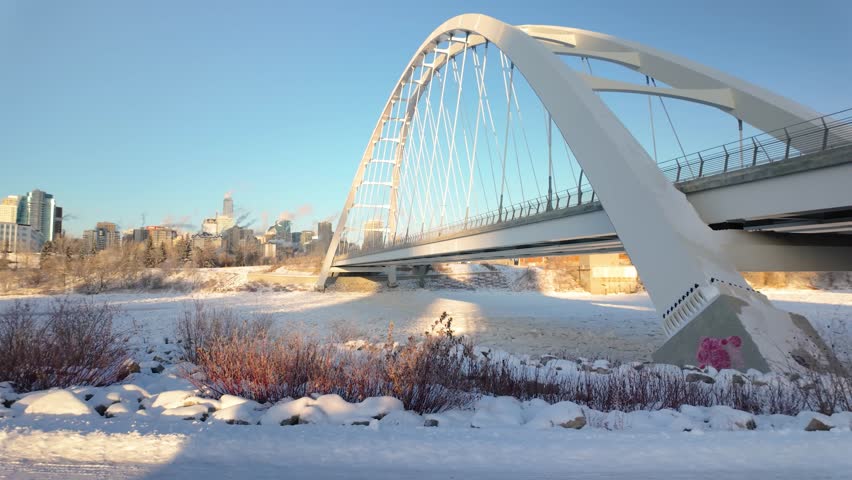 Left Side Of Walterdale Bridge, showcasing Highrise buildings Downtown Edmonton. A snowy river valley, and the cold beauty of the city