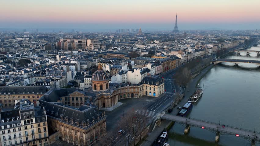 drone shot of Paris at sunrise with Seine river and Cite island, morning aerial view of Paris, capital of France, French tourism