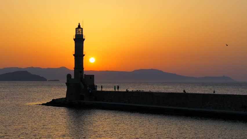 Chania town by night, Lighthouse, Drone shot, Crete, Greece, Aerial view of Chania with the amazing lighthouse, Beautiful Old city, Greece and best scenic places - panorama of picturesque old town 