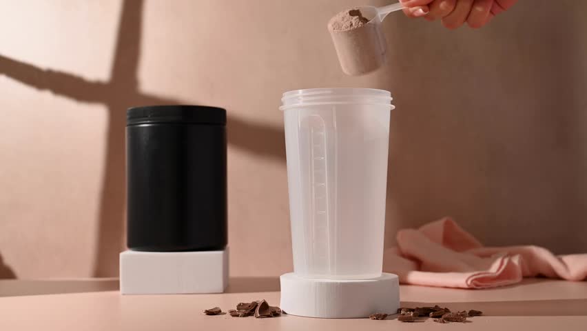 Chocolate protein powder, making a shake. Food supplement, fitness sport, health and nutrition.
