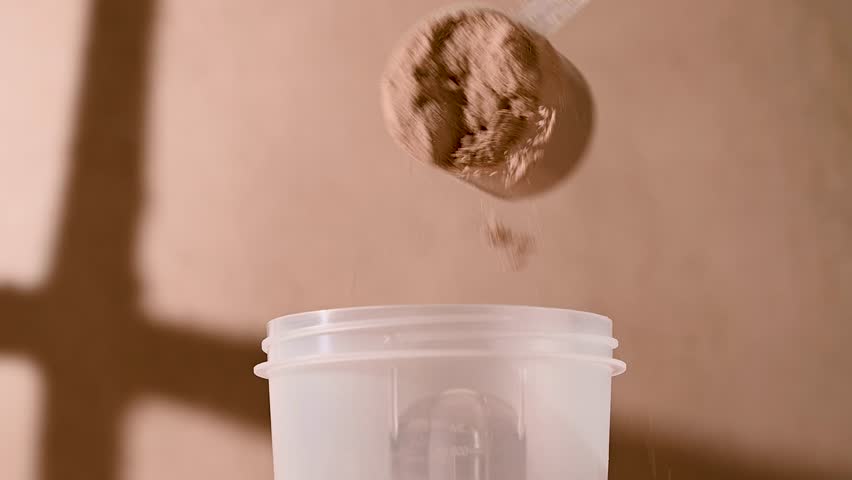 Chocolate protein powder, making a shake. Food supplement, fitness sport, health and nutrition.