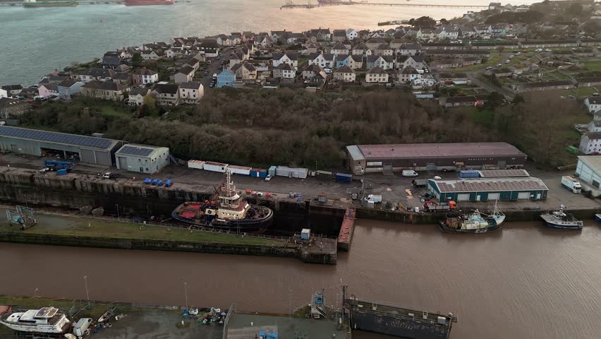 Milford waterfront, pembrokeshire, showing harbor, tugboat, and surrounding buildings, aerial view