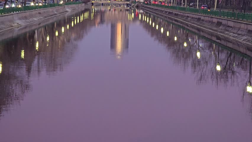 Cars traffic in Bucharest on the evening, near to Opera building, Casa Poporului, Dambovita River