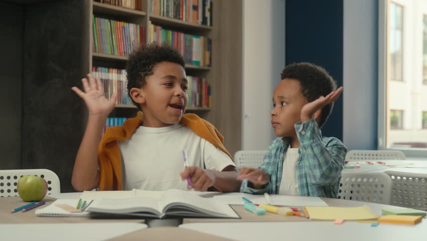 African American little boys kids siblings teamwork gesture give high five children schoolboys students pupils studying together school learning writing task cooperate primary education happy friends - Powered by Shutterstock - Get 15% off with code: PIKWIZARD15