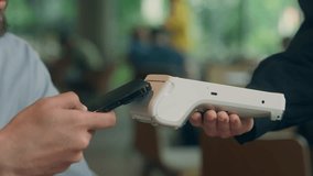 Contactless payment visitor customer business client buyer cafe man guy male businessman pay phone NFC smartphone purchase online bank credit card scan wifi technology terminal waiter serving cashless - Powered by Shutterstock - Get 15% off with code: PIKWIZARD15