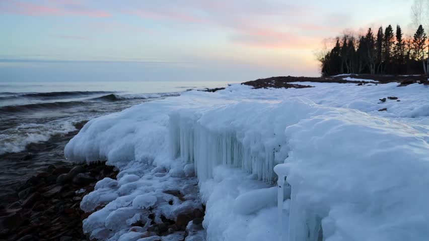 winter sunset at the lake superior shoreline in grand marais Minnesota