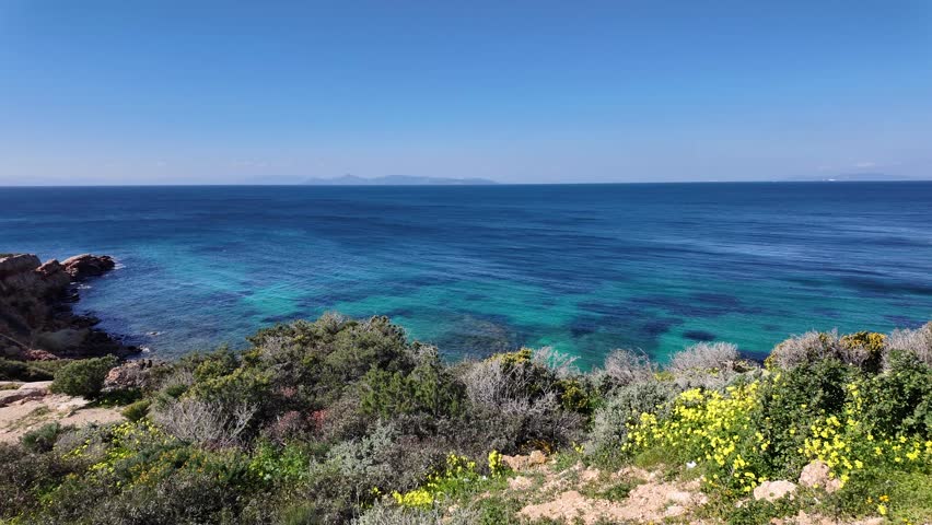 Vouliagmeni, Attica, Greece - March 5th, 2025 - parks, coastline, beach, town and aerial footage