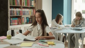 Cute girl little kid pupil teenager reading book library cognition primary education child student daughter reader learner textbook read prepare for lesson in school joyful happy schoolgirl smiling - Powered by Shutterstock - Get 15% off with code: PIKWIZARD15