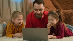 Caucasian family happy kids children dad man parent using laptop at home computer order online shopping father help little girls daughters school homework parental control watching cartoons together - Powered by Shutterstock - Get 15% off with code: PIKWIZARD15