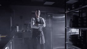 Cheerful chef in uniform standing in restaurant kitchen - Powered by Shutterstock - Get 15% off with code: PIKWIZARD15