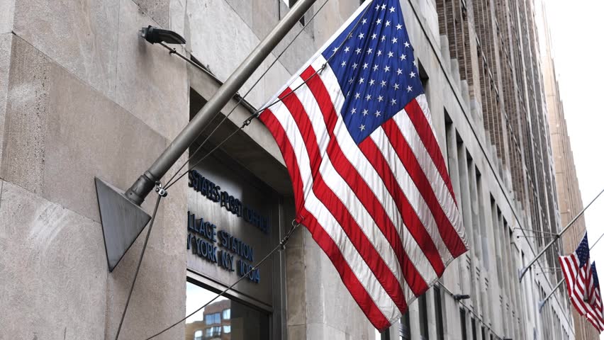 us american flag waiving in the breeze wind in front of post office on varick street (united states of america usa) stars and stripes