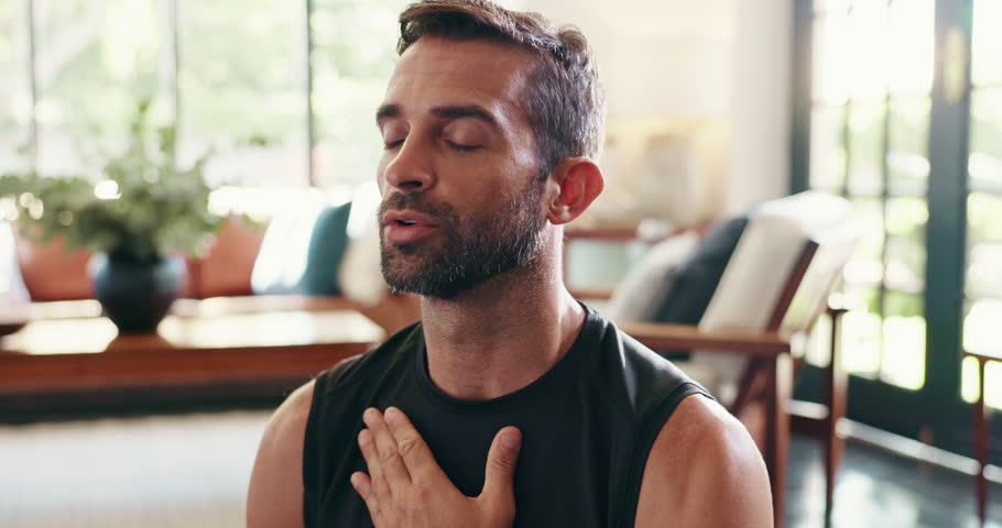 Breathing, mindfulness and yoga with man in living room of home for balance or inner peace. Fitness, meditation and wellness with calm person in apartment for awareness or mental health exercise