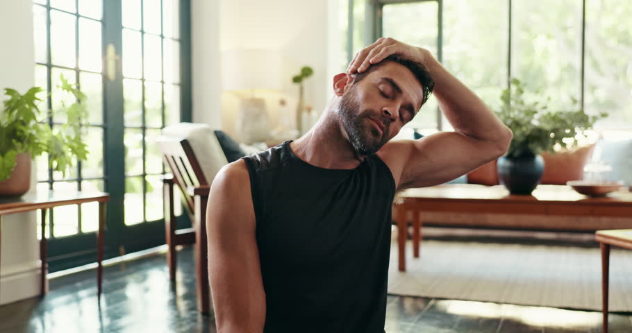 Man, fitness and stretching with neck for exercise, training or workout preparation on floor at home. Active, male person or physical wellbeing with warm up for yoga, health and wellness at house