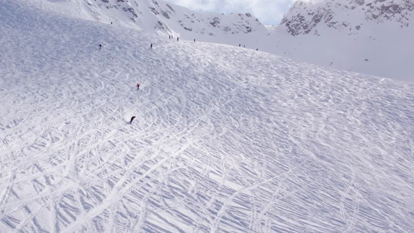 Snowboarders with breathtaking mountain vista, aerial footage, ski mountain, sunny day, winter, ski hill, Whistler BC. 5.4K 24FPS