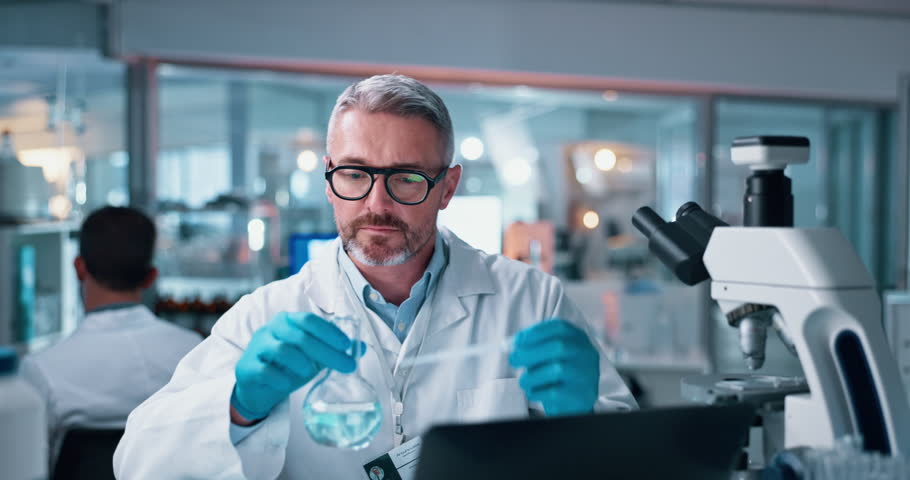 Scientist, mature man and chemical with microscope testing for chemistry, study or medical research. Biotech, laboratory and analysis with liquid inspection for pharmaceutical or pathology experiment
