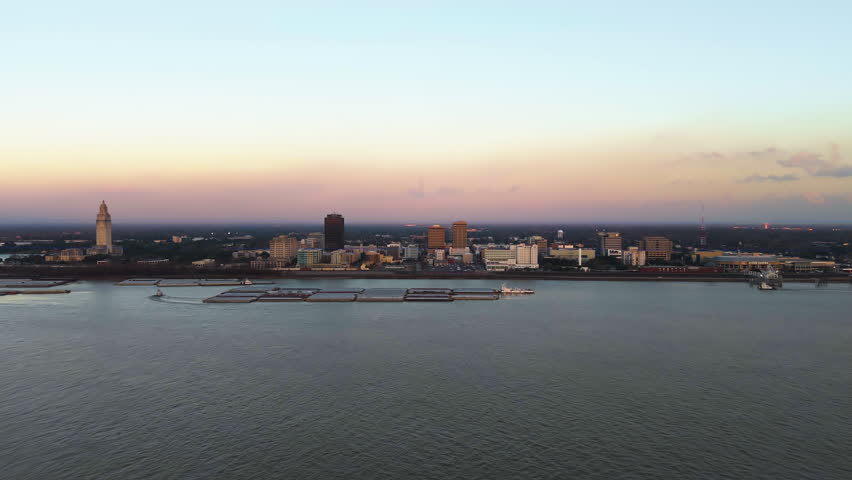 Establishing drone shot approaching the skyline of Baton Rouge, sunset in La, USA