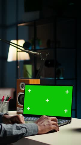 Vertical Video Self employed person checking financial graphs on chroma key screen, researching and sharing insight. Remote worker comparing business graphic economic figures, creating a strategy