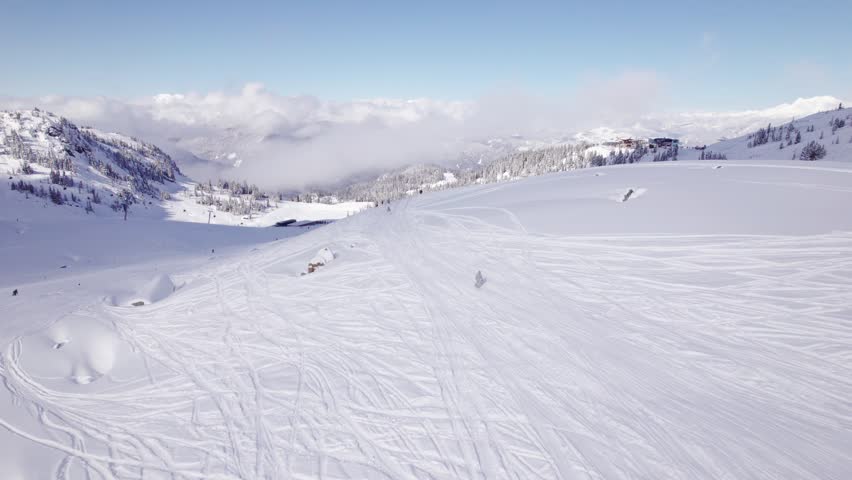 Snowboarders with breathtaking mountain vista, aerial footage, ski mountain, sunny day, winter, ski hill, Whistler BC. 5.4K 24FPS