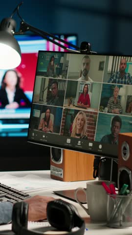Vertical Video African American man and associates attending a virtual meeting call in his loft, discussing and communicating through a video conference, doing remote work at home. Camera B.