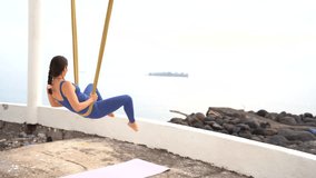 Yoga instructor performing an upside down pose using an aerial yoga hammock, promoting mindfulness and flexibility - Powered by Shutterstock - Get 15% off with code: PIKWIZARD15