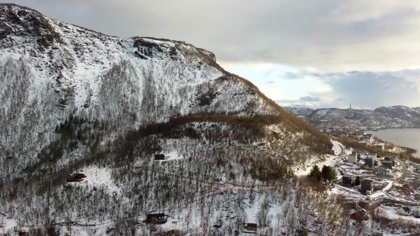Experience the Arctic winter in 4K with this drone footage of Bodø, Norway. Snowy mountains, icy fjords, and serene landscapes make this video a must-have