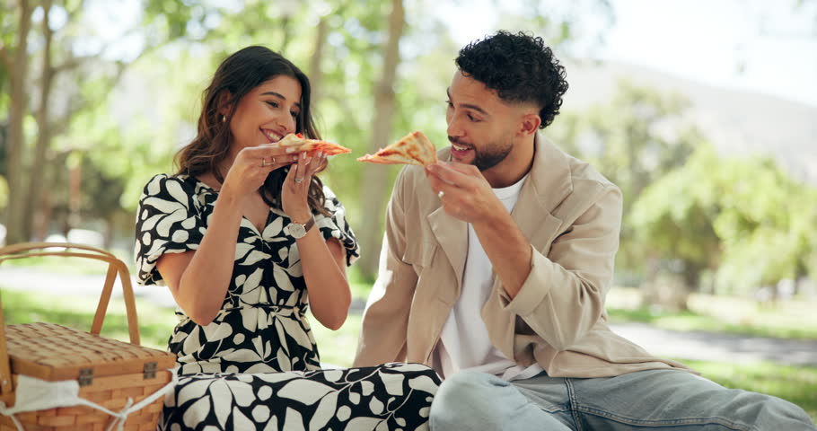 Pizza, couple and happy with picnic at park for outdoor date, eating fast food and bonding together. Romance, people and relax with lunch in nature for takeaway meal, hungry and relationship support