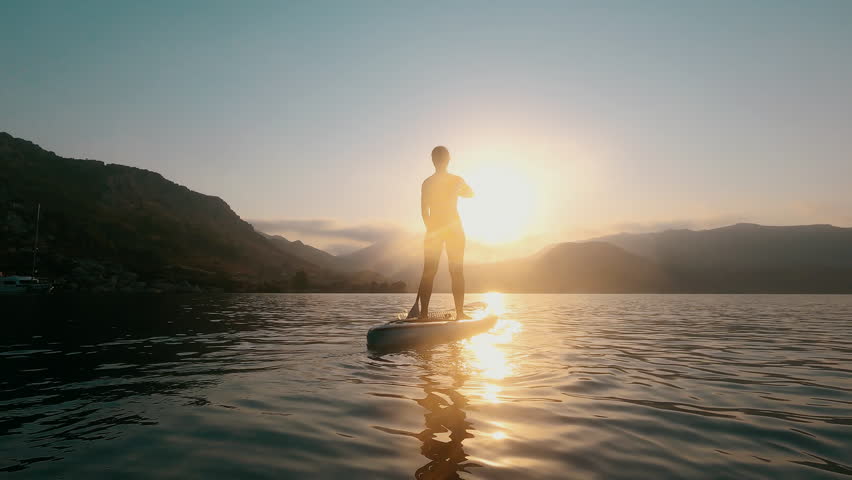 Woman silhouette on Water, Sup board, paddle boarding in slow motion