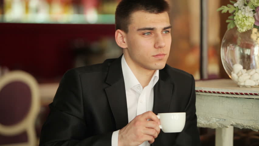 Closeup portrait of a businessman drinking coffee in a cafe