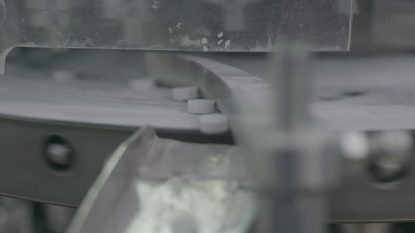 machine that collects and separates aspirins after they have been refined and processed, ensuring quality control.