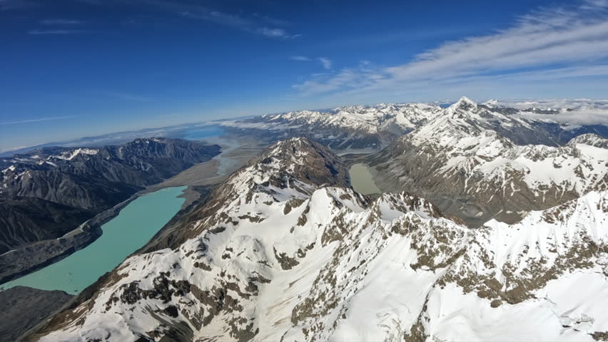 POV helicopter flying down from Aoraki mount cook summit with the Tasman Lake and Lake Pukaki visible, Southern Alps New Zealand