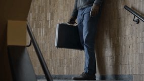 Two people exchanging black suitcase in sketchy location subway or underground. Shaking hands after suspicious deal or secret transaction of crime in black market. Payoff bribe illegal deal operation - Powered by Shutterstock - Get 15% off with code: PIKWIZARD15