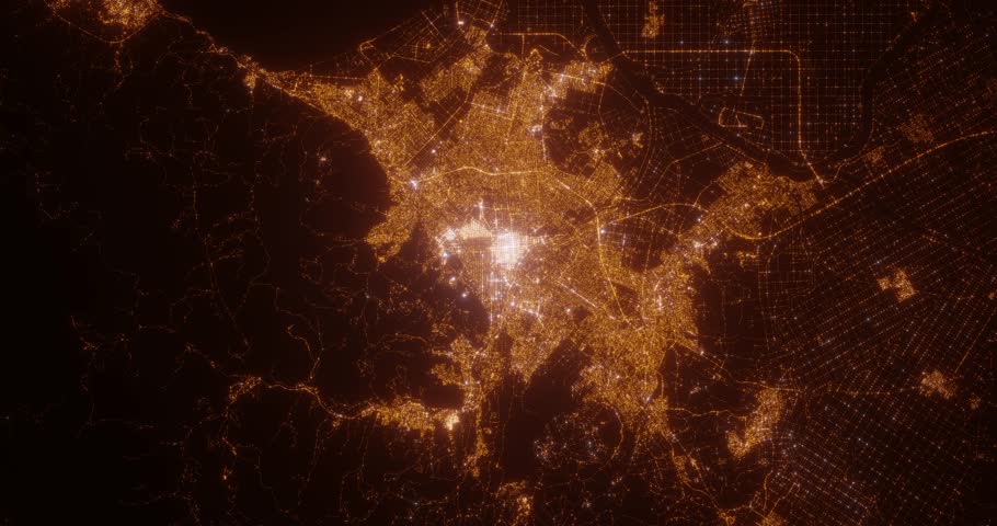 Sapporo (Japan) aerial view at night. Top view on modern city with street lights. Camera is zooming out, rotating clockwise