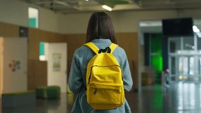 Unrecognizable woman walking going to class Caucasian female teenager girl student teenage pupil in school corridor hall lesson academy education with yellow schoolbag learn indoor schooling exams - Powered by Shutterstock - Get 15% off with code: PIKWIZARD15
