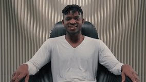 African American ethnic happy smiling positive cyber man in white room futurism studio indoors male guy looking at camera smile carefree sitting in chair computer technology modern futuristic space - Powered by Shutterstock - Get 15% off with code: PIKWIZARD15