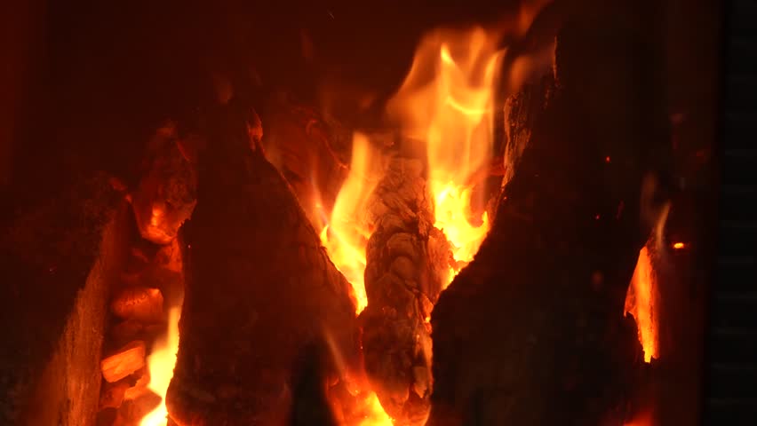 The fire burns slowly in the fireplace