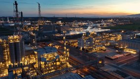 Drone shot of Oil Refinery at sunset. Chemical Production, Crude Oil Refinery Plant with Chimney tower, petrol production, environmental pollution - Powered by Shutterstock - Get 15% off with code: PIKWIZARD15