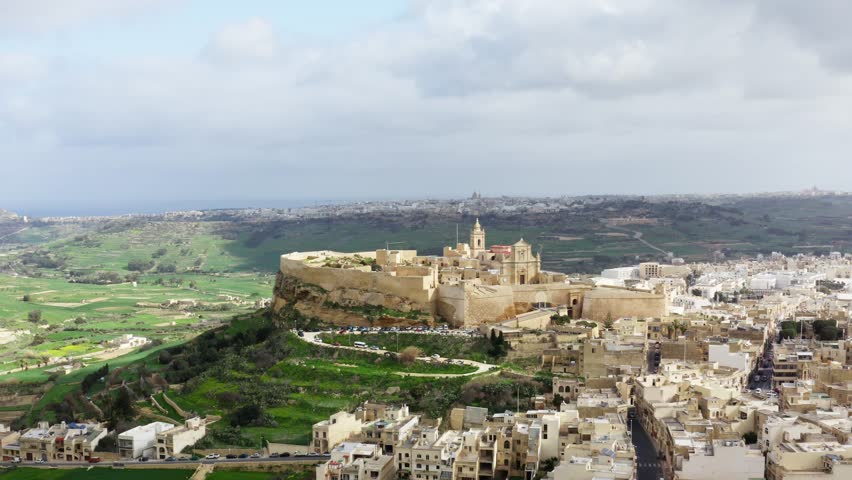 Aerial orbiting shot of Citadella de Victoria in Gozo Malta, during cloudy weather, drone