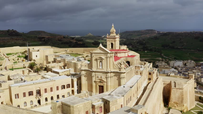 Aerial close shot of the Cathedral of the assumption in Gozo, Malta during cloudy weather