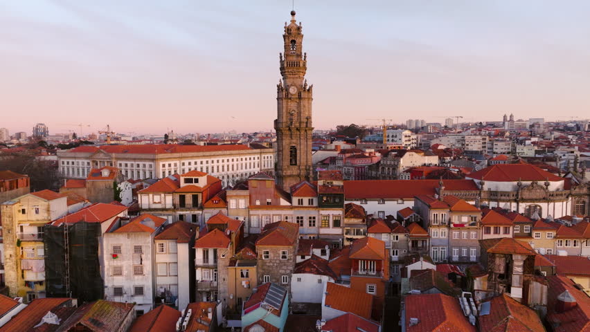 Bell Tower Of Clerigos Church And Porto City Houses In Portugal. - aerial pullback shot