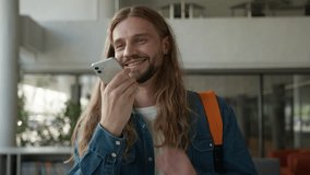 Happy positive user record voice mail audio message talk to smartphone microphone send sound answer male in college university talking Caucasian man guy student smiling speak mobile phone AI command - Powered by Shutterstock - Get 15% off with code: PIKWIZARD15