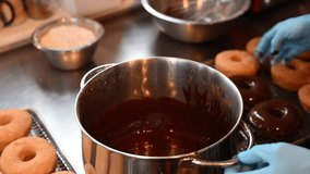 Golden donuts fresh from the fryer, ready for their final touch, a rich, glossy chocolate glaze that makes them irresistible - Powered by Shutterstock - Get 15% off with code: PIKWIZARD15