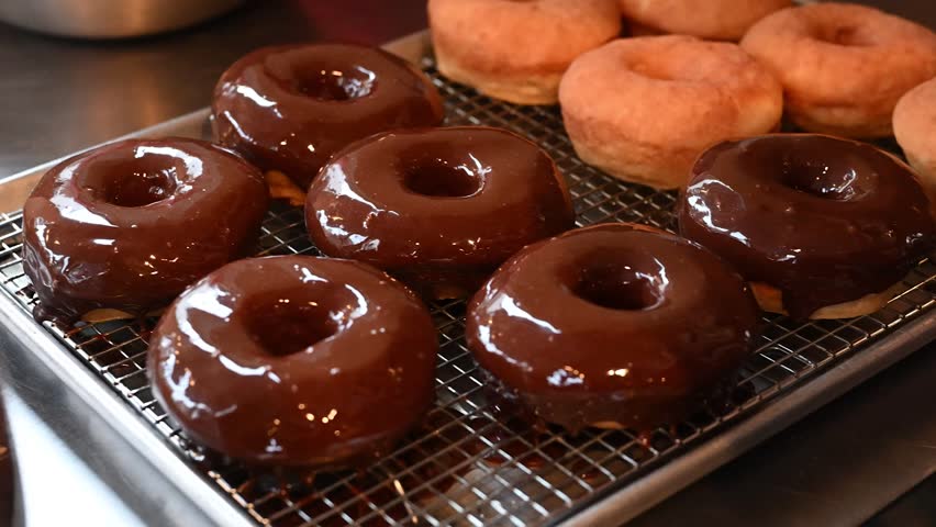 A close-up shot of delicious donuts that are coated in a smooth, glossy glaze, creating a moment of pure bliss.