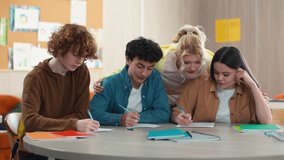 Four school Caucasian students pupils studying indoors male female prepare exams write homework teamwork learning men women girls guys teenagers writing discuss talking cooperation communicate friends - Powered by Shutterstock - Get 15% off with code: PIKWIZARD15