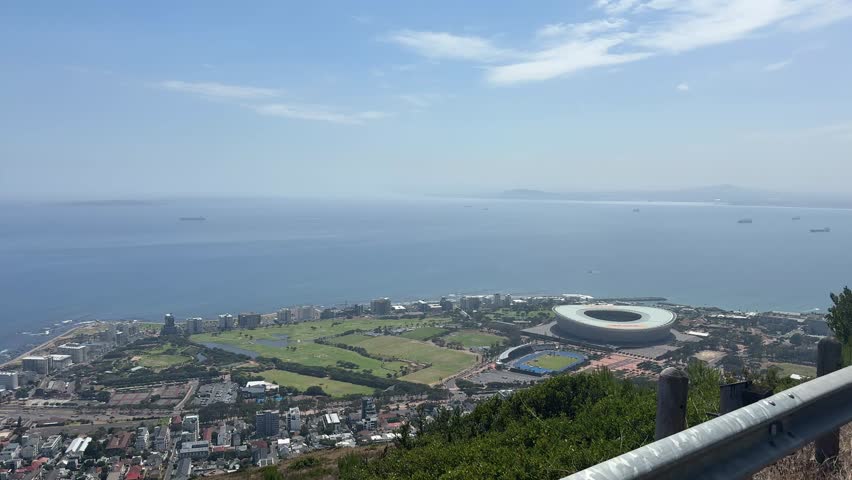 A driving POV shot of the Cape Town Stadium as viewed from the signal Hill Road.