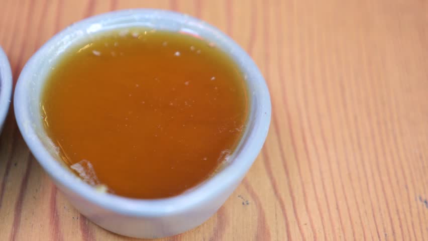 Golden Honey and olive on a small bowl on table 