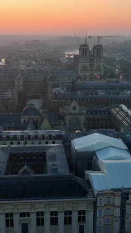 vertical video: drone shot of Paris, capital of France, aerial view in the morning, sunrise in Paris near Notre Dame, flying above Seine river in Paris at dawn. 