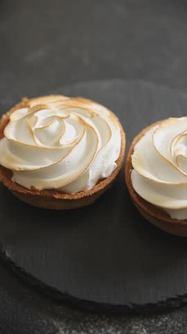 Lemon tart sweet dessert meringue, lemon curd, shortcrust pastry tasty fresh delicious gourmet food background table rustic food top view copy space
