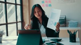 Young female professional sharing financial data via digital tablet during virtual conference in contemporary workspace - Powered by Shutterstock - Get 15% off with code: PIKWIZARD15