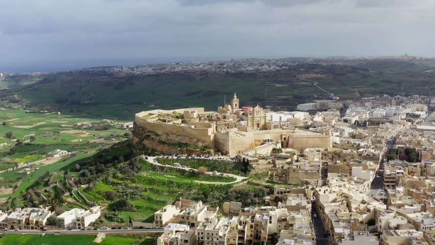 Aerial revealing shot of Citadella de Victoria in Gozo Malta, during cloudy weather, drone