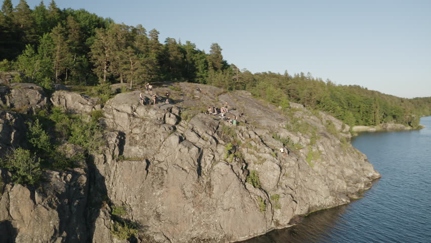 Cliffjumping in sweden, sunset evening, drone shot